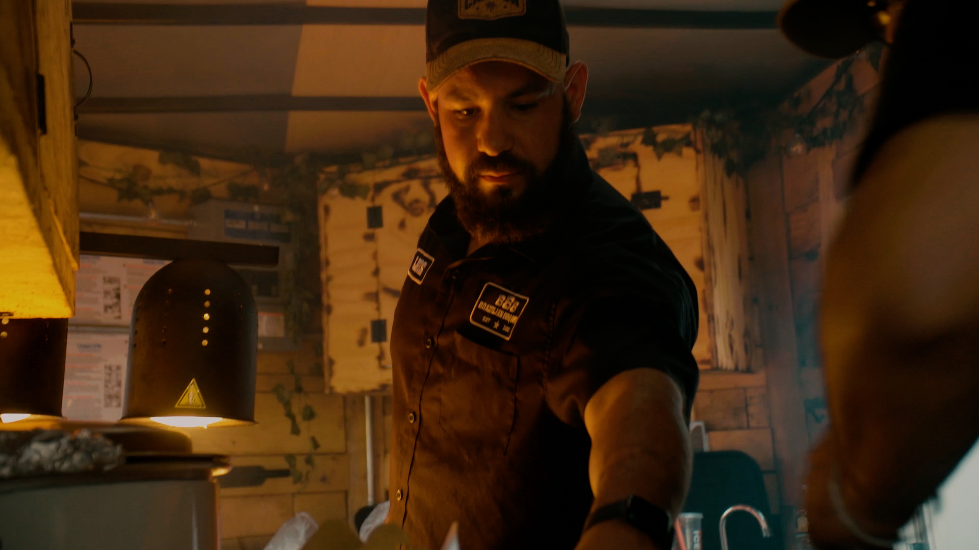 Luis expertly managing orders and operations in the Brazilian BBQ Boys trailer