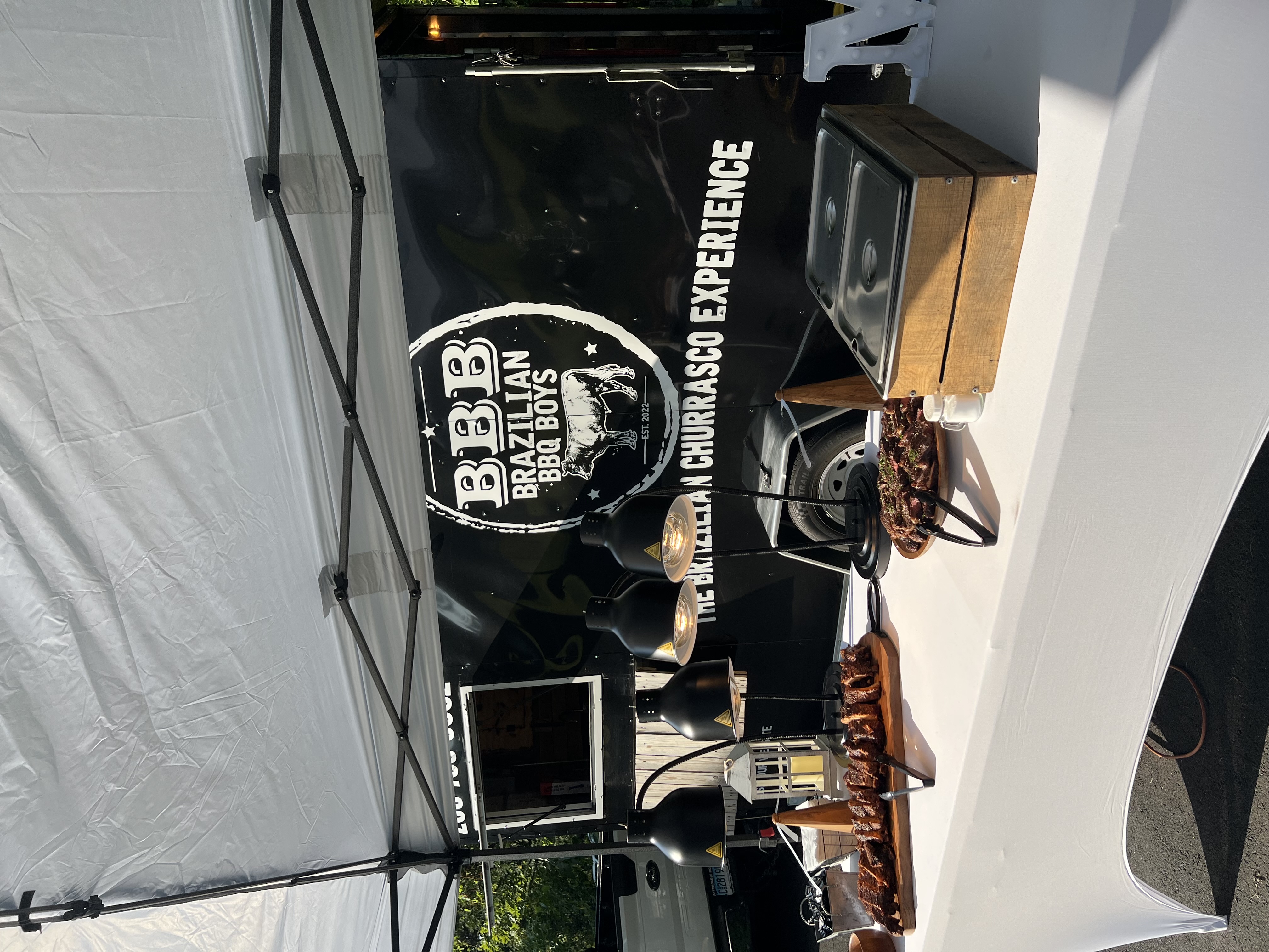 Wedding reception catering with Brazilian BBQ churrasco station and elegant table decorations in Connecticut