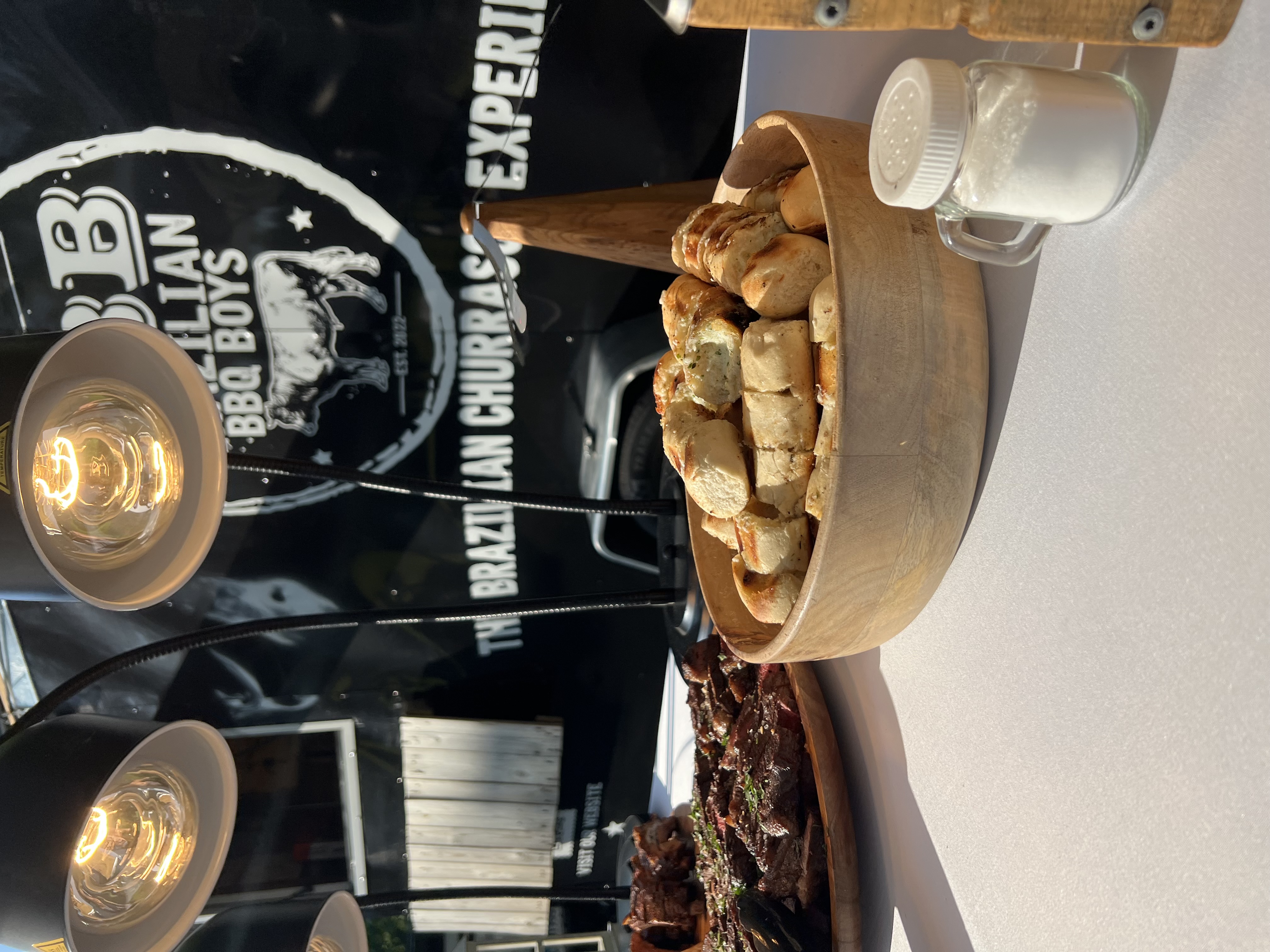 Fresh pão de alho garlic bread in a wooden bowl at the BBQ Boys serving station